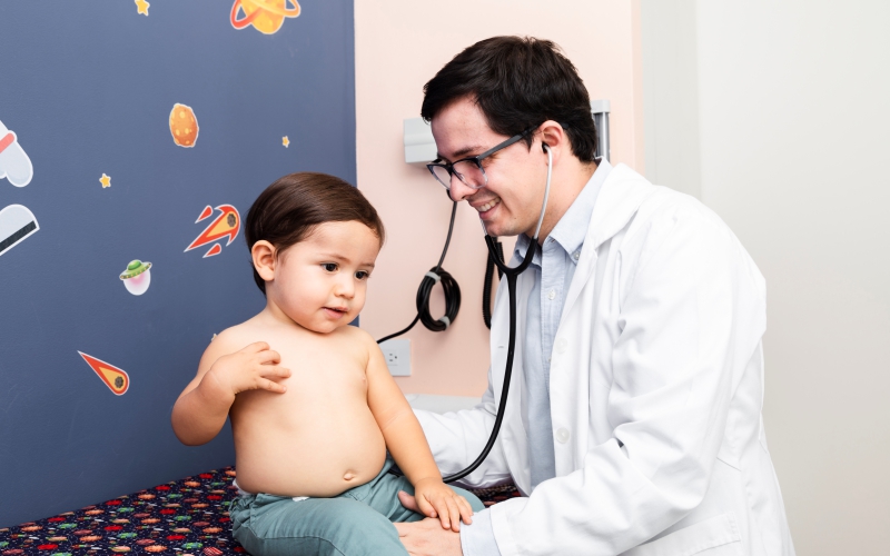 Pediatrician consulting toddler at Vasavi Hospitals Bangalore