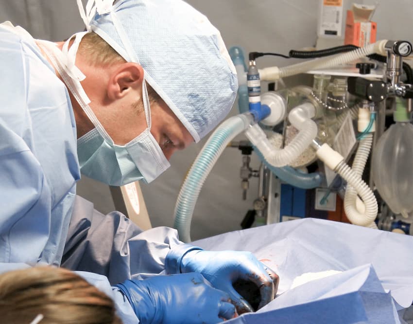 Vascular surgeon performing operation with advanced surgical equipment at Vasavi Hospitals