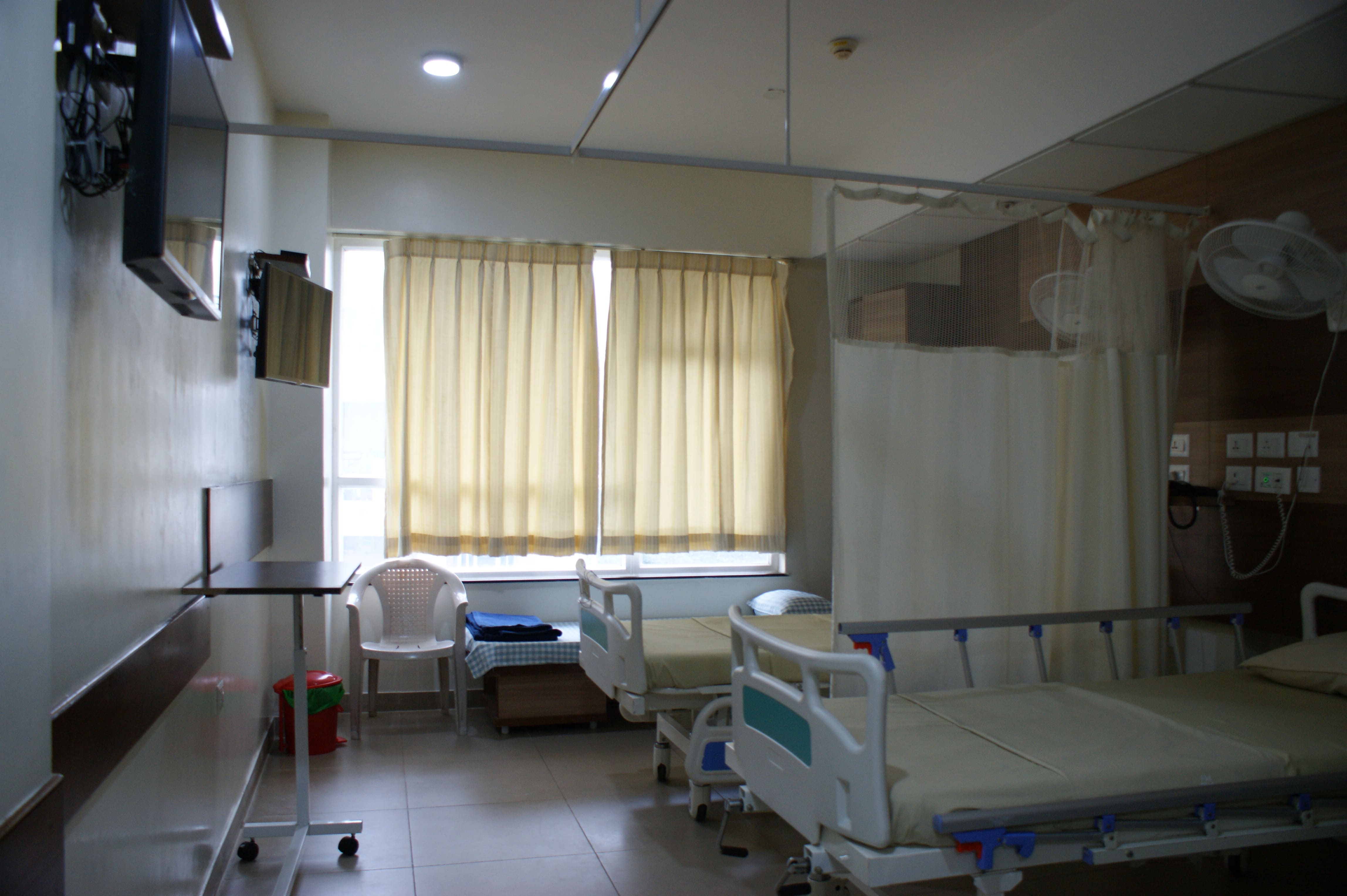Comfortable hospital room with twin beds at Vasavi Hospitals Bangalore for patient recovery.